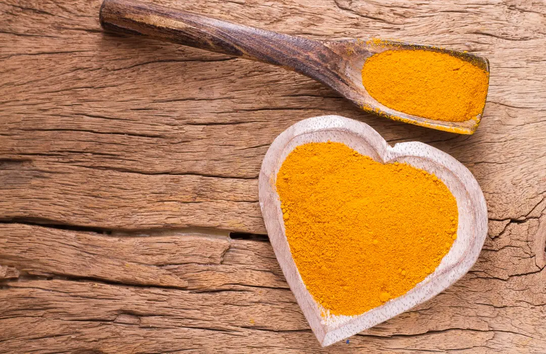 turmeric-powder-bowl-wood.webp